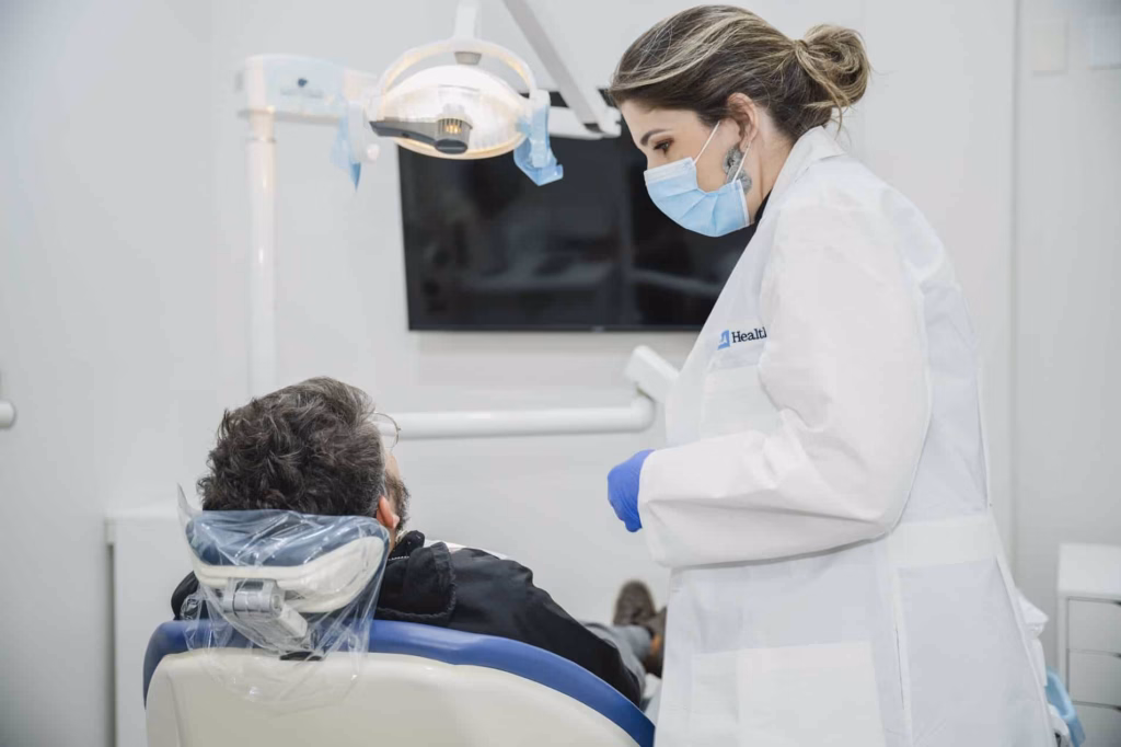 Introducing BB Dental Care, where a woman is sitting in a dentist's chair.
